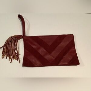 Carlos Santana burgundy clutch